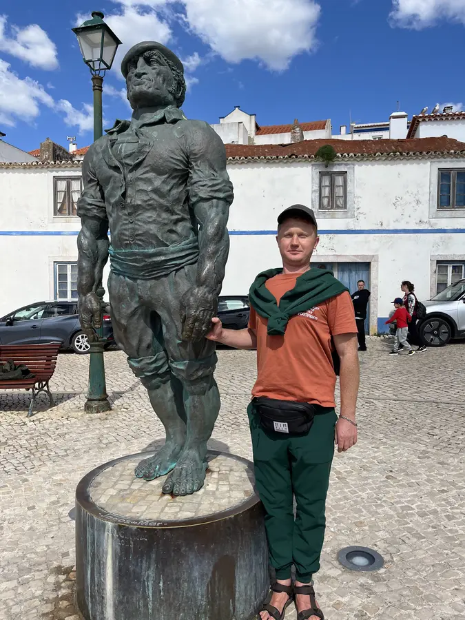Posing next to a statue in town