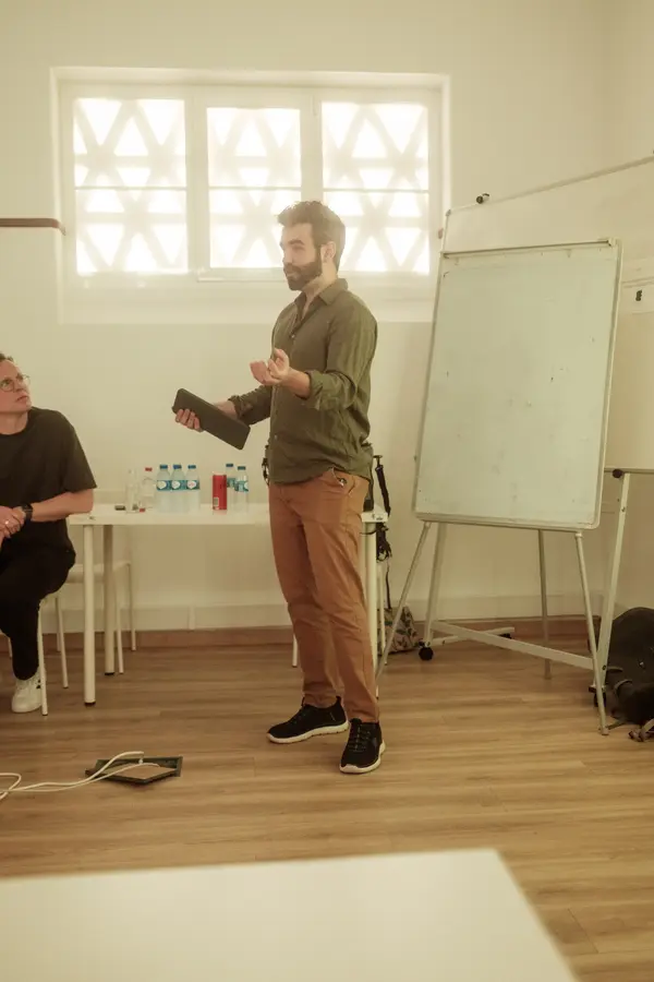 A speaker presenting next to the flip chart