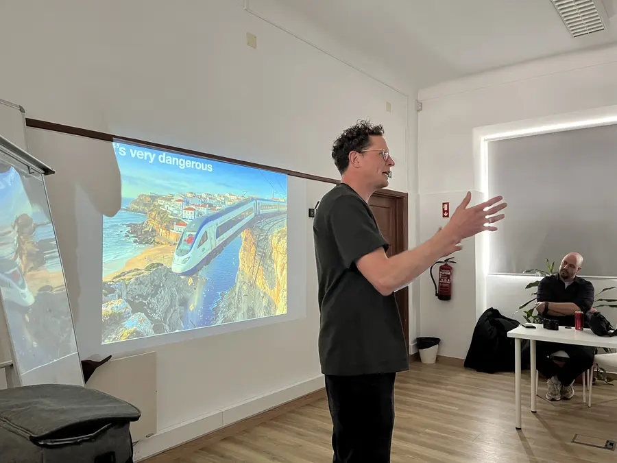A speaker presenting with slides on the projector