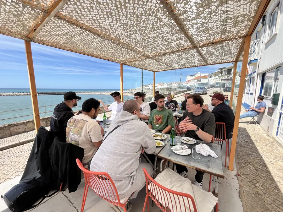 The group at lunch on a terrace by the sea